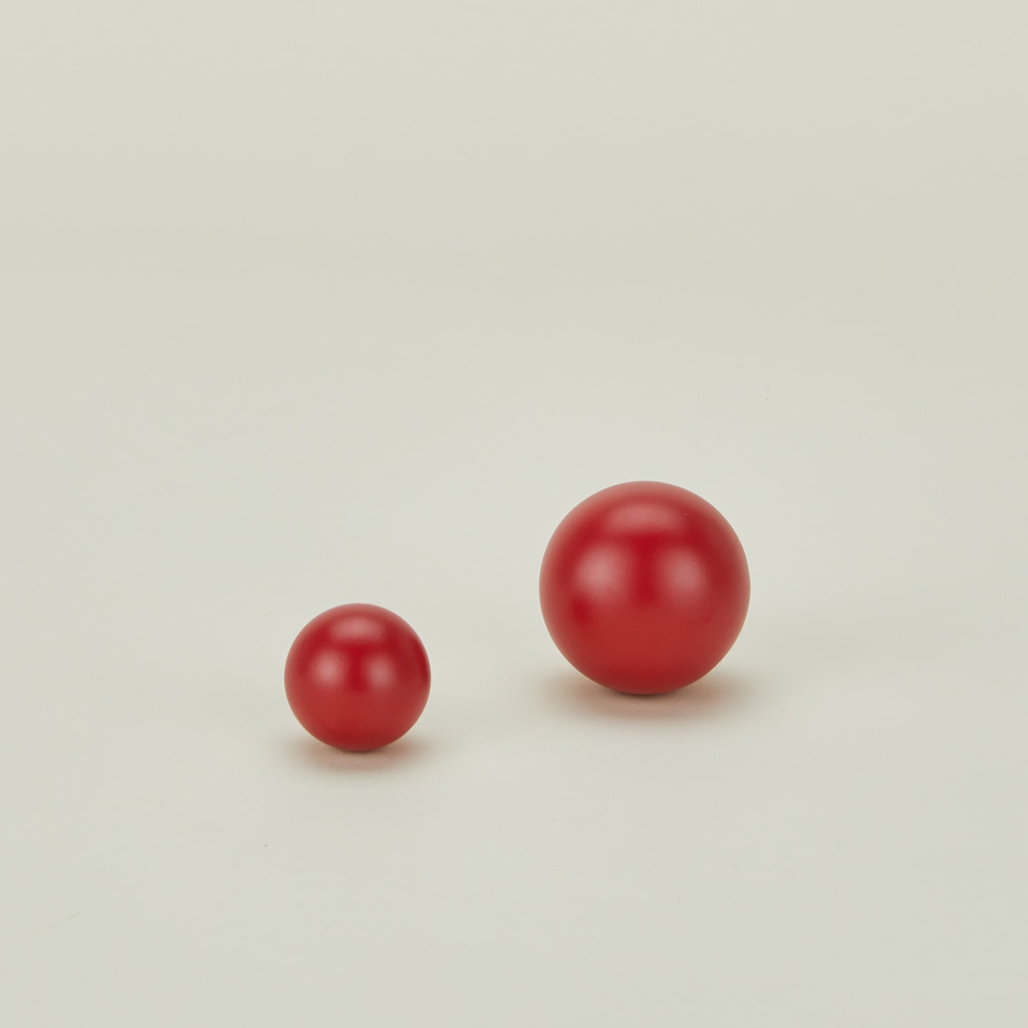 Large and small essential sphere knobs in red