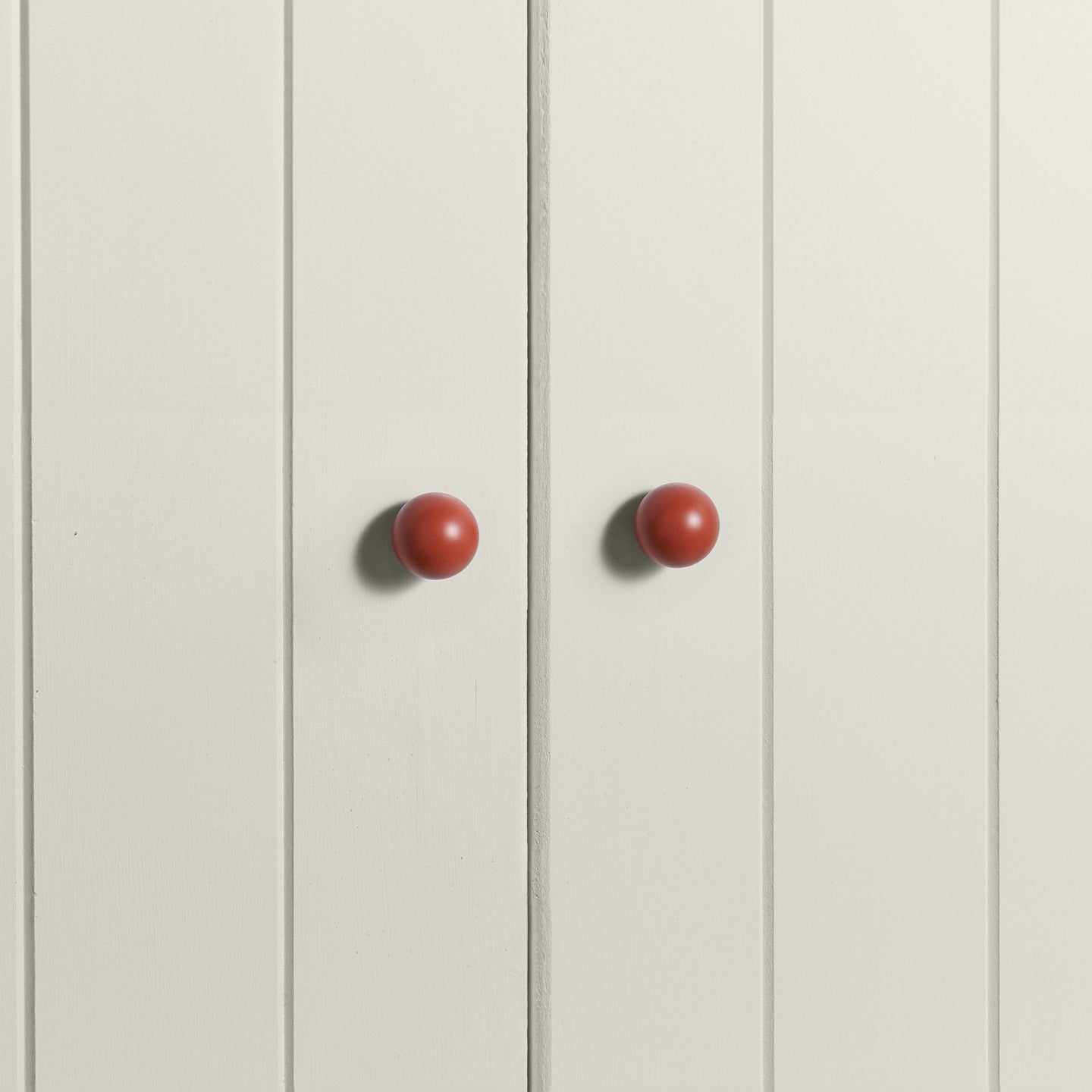 Small terracotta essential sphere knobs on white doors