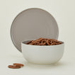Essential Serving Bowl and Serving Platter in Light Grey, with pretzels.