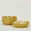 Four Essential Low Bowls in Mustard, with tortilla chips.
