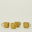 Four Essential Mugs in Mustard, with coffee.