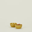 Two Essential Extra Small Bowls in Mustard filled with nuts.