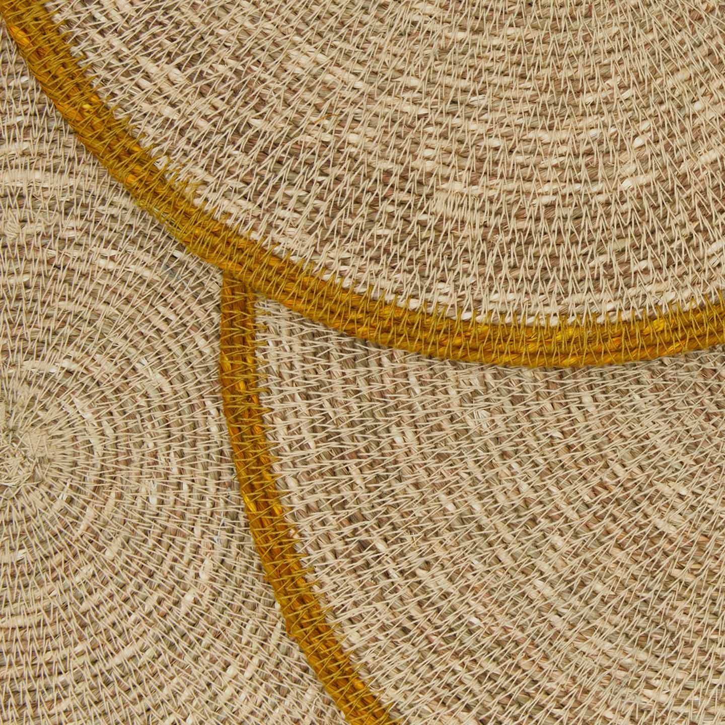 Close up view of essential woven placemat in mustard