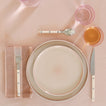 Placesetting with Essential Striped Dinner Napkin in Blush and Terracotta on pink tablecloth.
