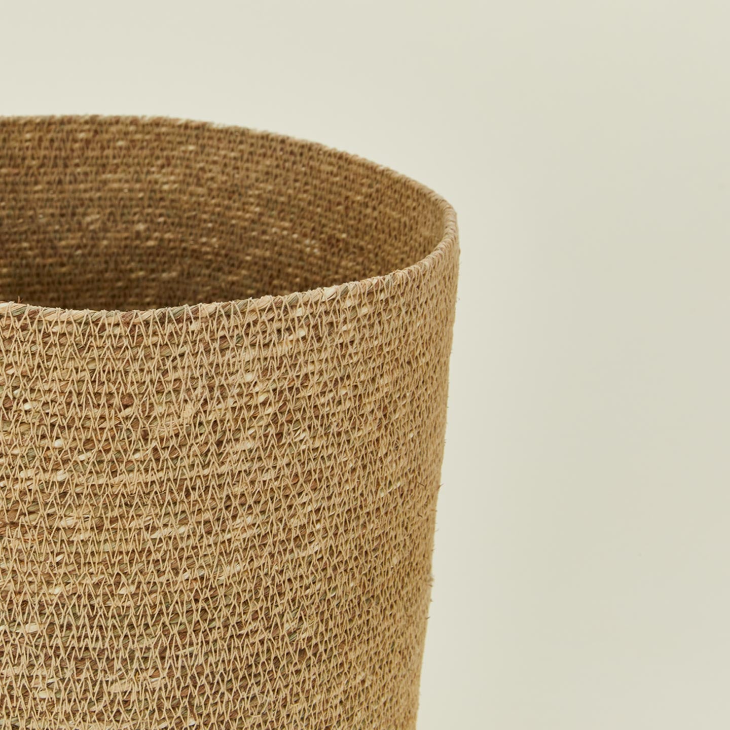 Close up view of Essential woven wastebasket in natural