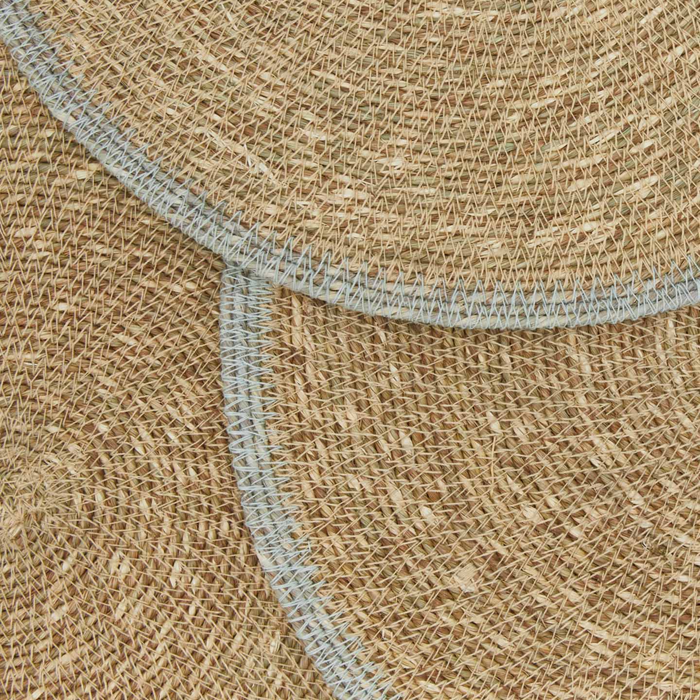 Close up view essential woven placemats in sky.