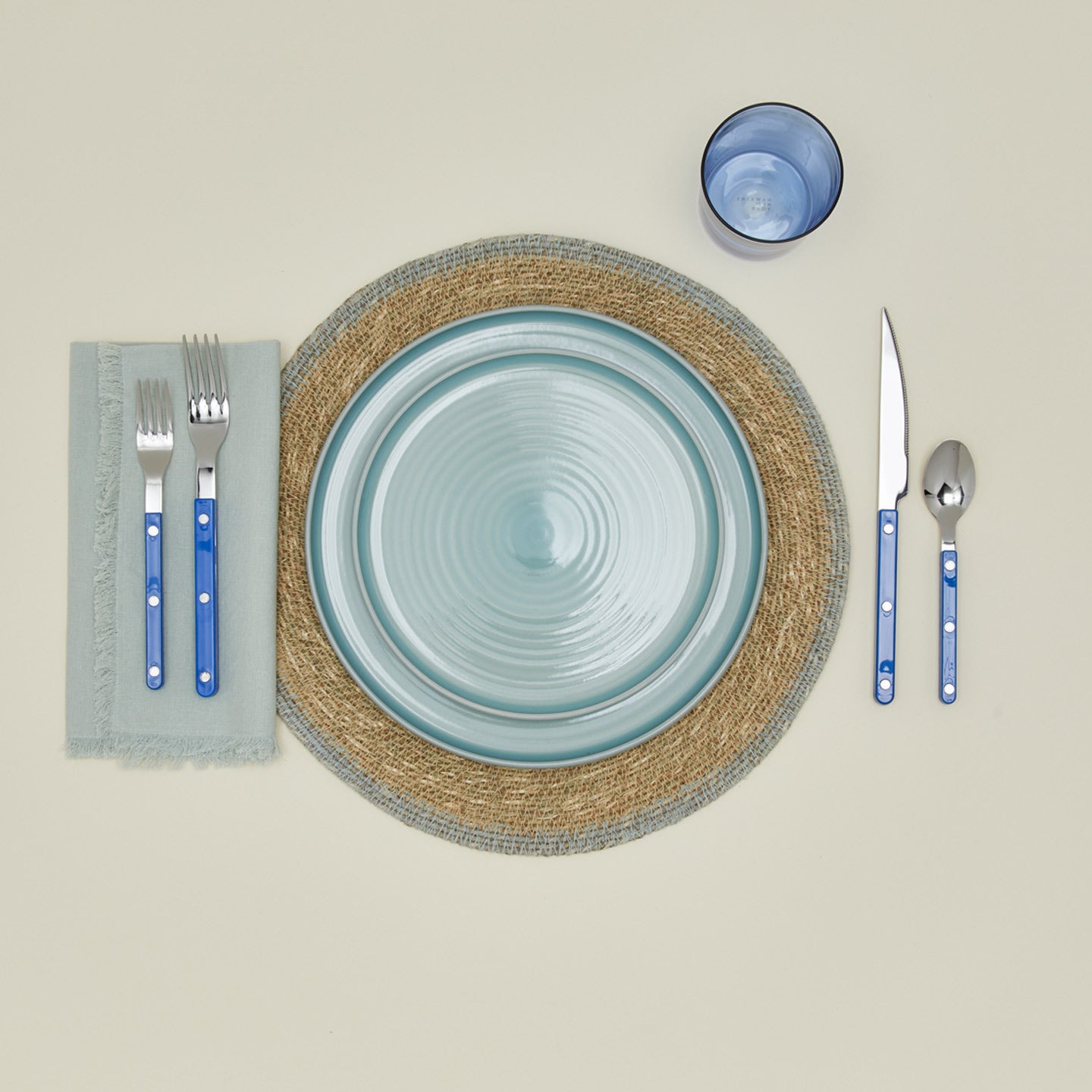 Essential woven placemat in sky with place setting
