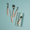 Essential Striped Napkin in Sky with blush flatware on light blue background.