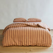 Essential Stripe Pillowcases, Set of 2 - Blush/Terracotta on bed with matching duvet.
