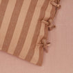 Close up view of essential striped pillowcase in blush/terracotta
