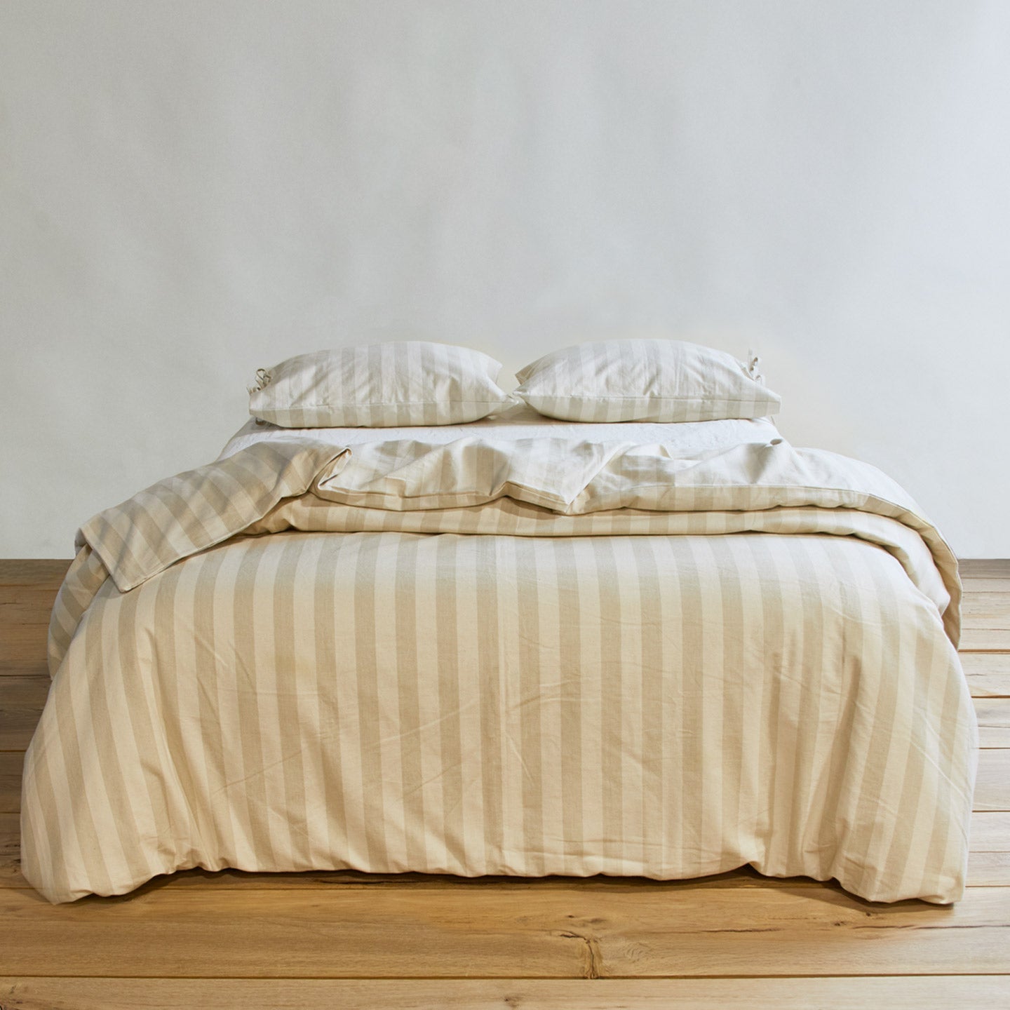 Essential Stripe Pillowcases, Set of 2 - Ivory/Flax on bed with matching duvet