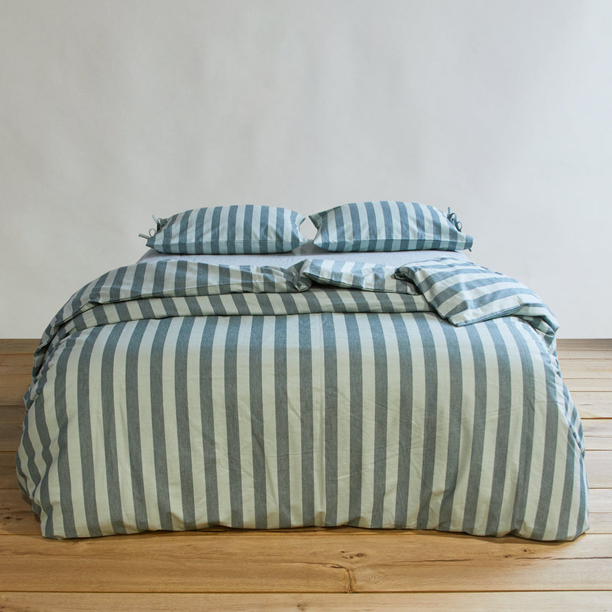 Essential Stripe Pillowcases, Set of 2 - Sky/Peacock on bed with matching duvet