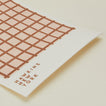 Close up view of essential swedish dishcloths in blush/terracotta