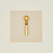 Brass ice cream scoop on a beige background