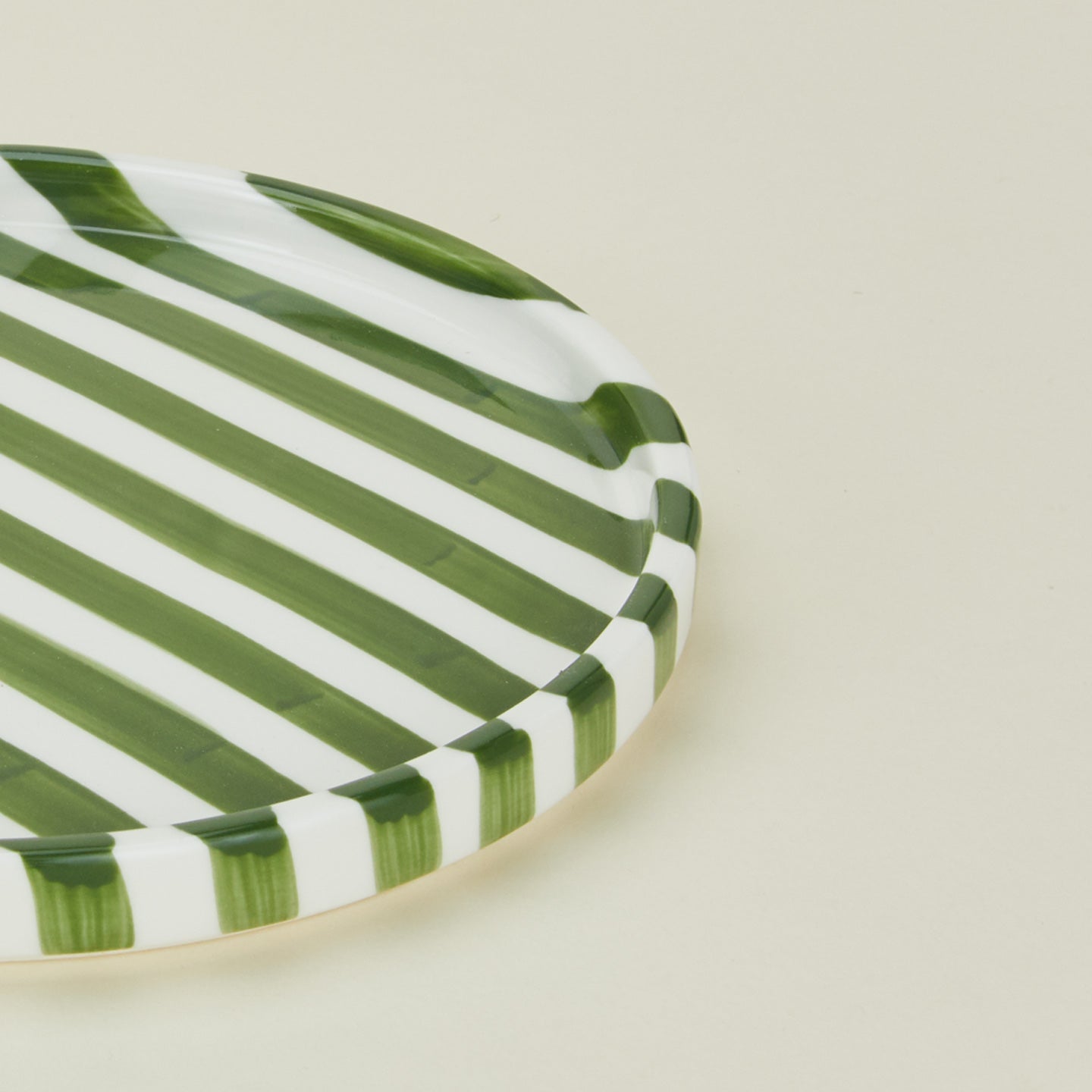 Close up view of Fodory olive striped dinner plate