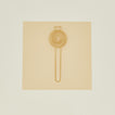 Brass swirl egg separator on beige paper on ivory background.