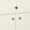 Brass knobs in large and small on cabinet doors