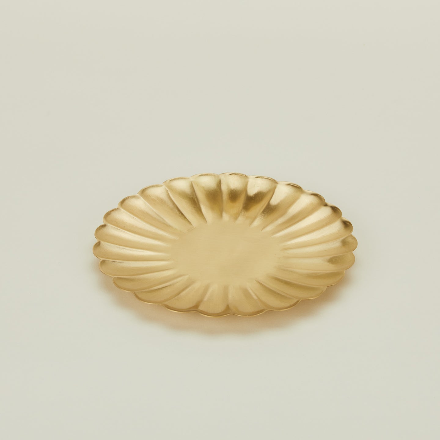 Close up view of large brass petal plate 