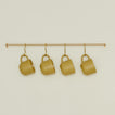 Large brass towel bar with mustard colored essential mugs hanging on hooks