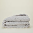 A folded checked linen duvet cover.