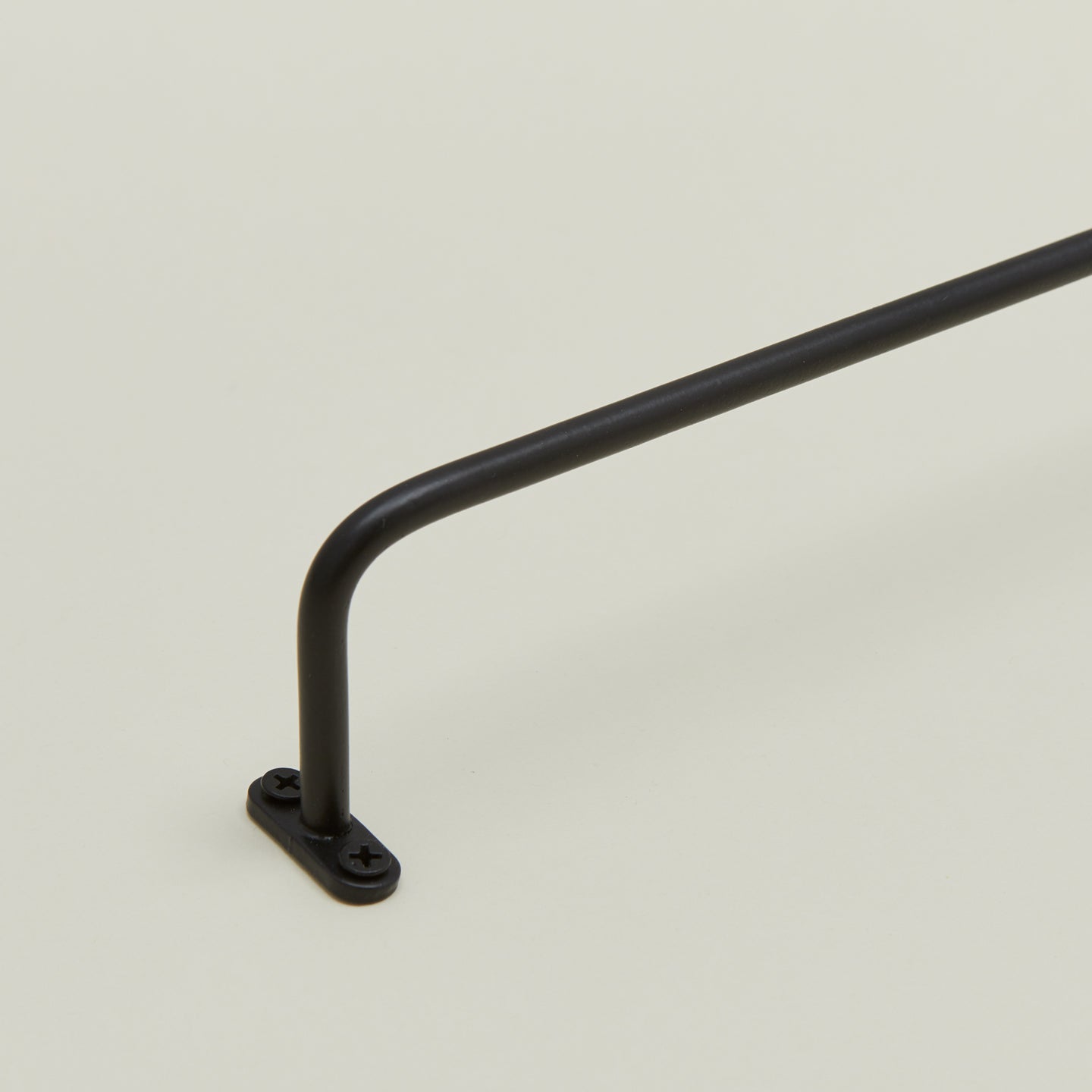 Close up view of iron towel bar mounting flange