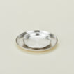 Three quarter view of stacked small and medium silver plates