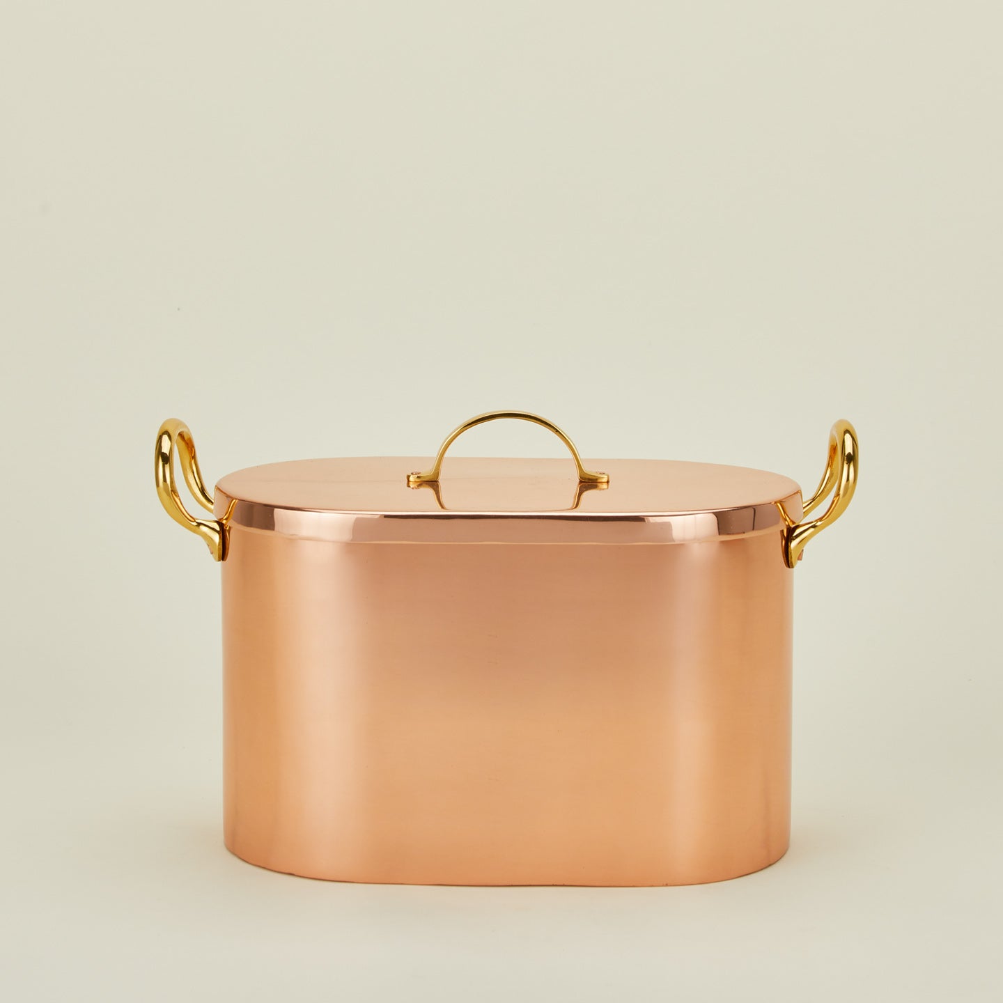 Copper bread box with lid on ivory background.