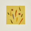Colorful vegetable candles on a yellow background