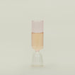 Flute glass with clear stem and pink cup, filled with sparkling wine.