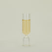 Flute glass with clear stem and clear cup, filled with sparkling wine.