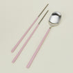 Close up view of Illo spoon and chopstick set in pink