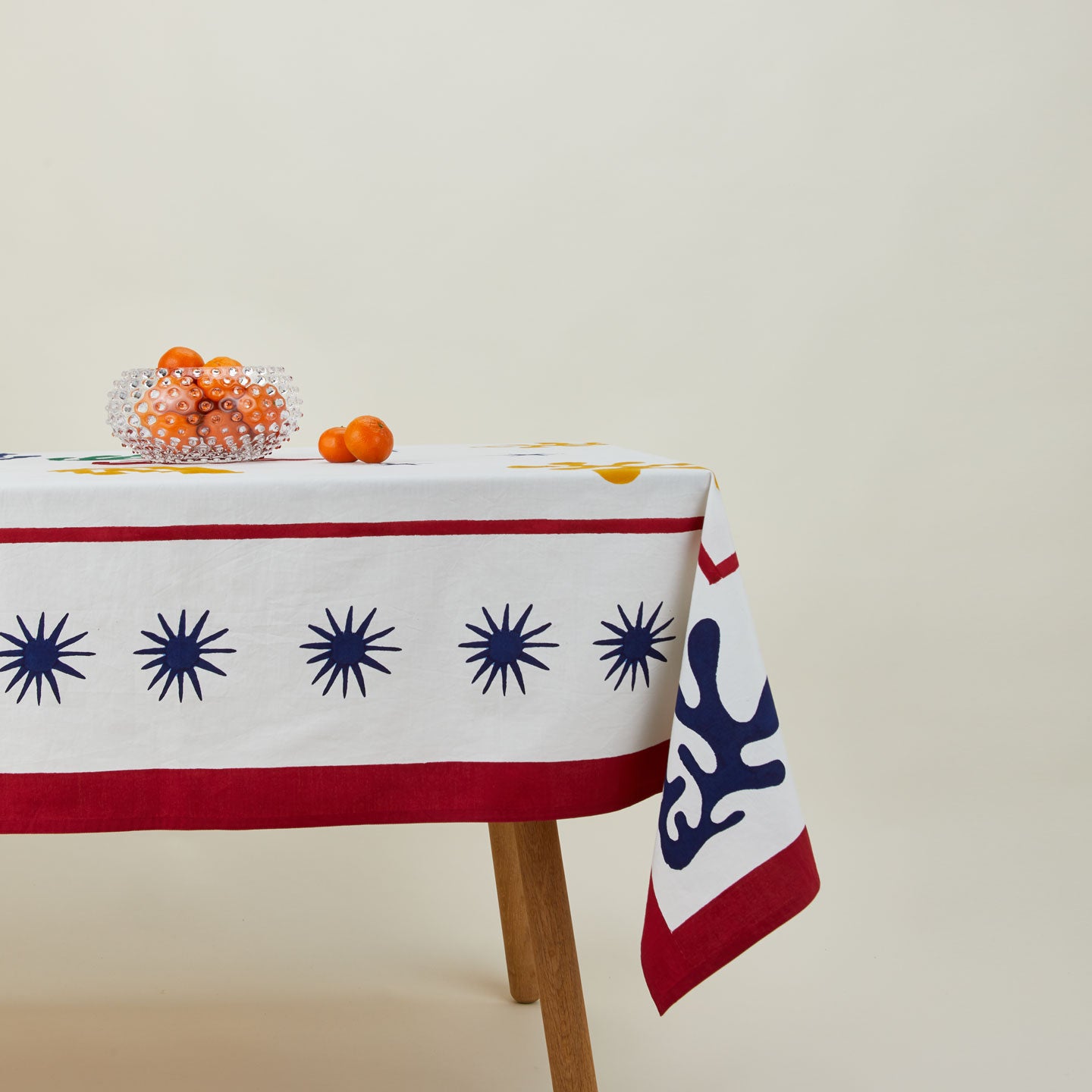 Inner Child celestial tablecloth on table with bowl of oranges.