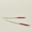 Close up view of Jean Dubost carving set in red