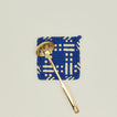 Dots and dashes potholder in blue and yellow with brass ladle