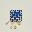 Parquet potholder in blue and yellow with brass measuring spoons