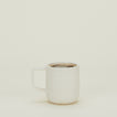 Stoneware Pigment Mug in Ivory filled with hot cocoa.