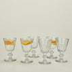 Six Perigord water glasses, some with fruit infused water.