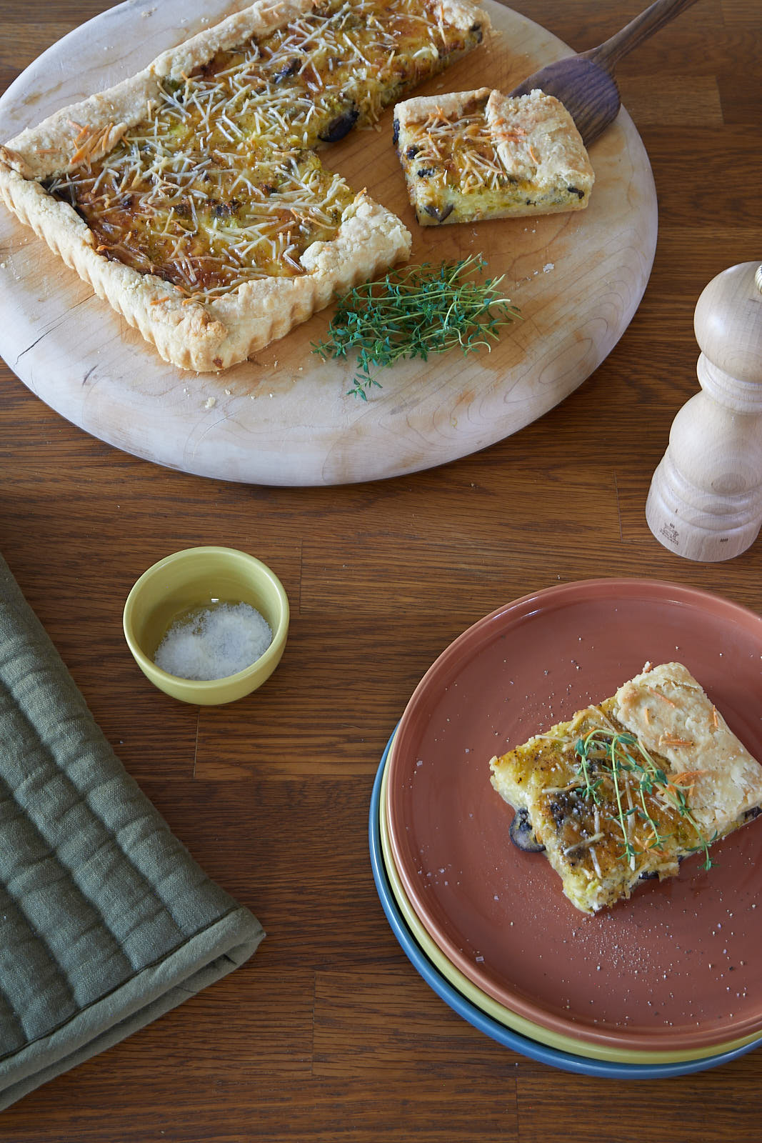 A leek and mushroom tart on a kitchen table.