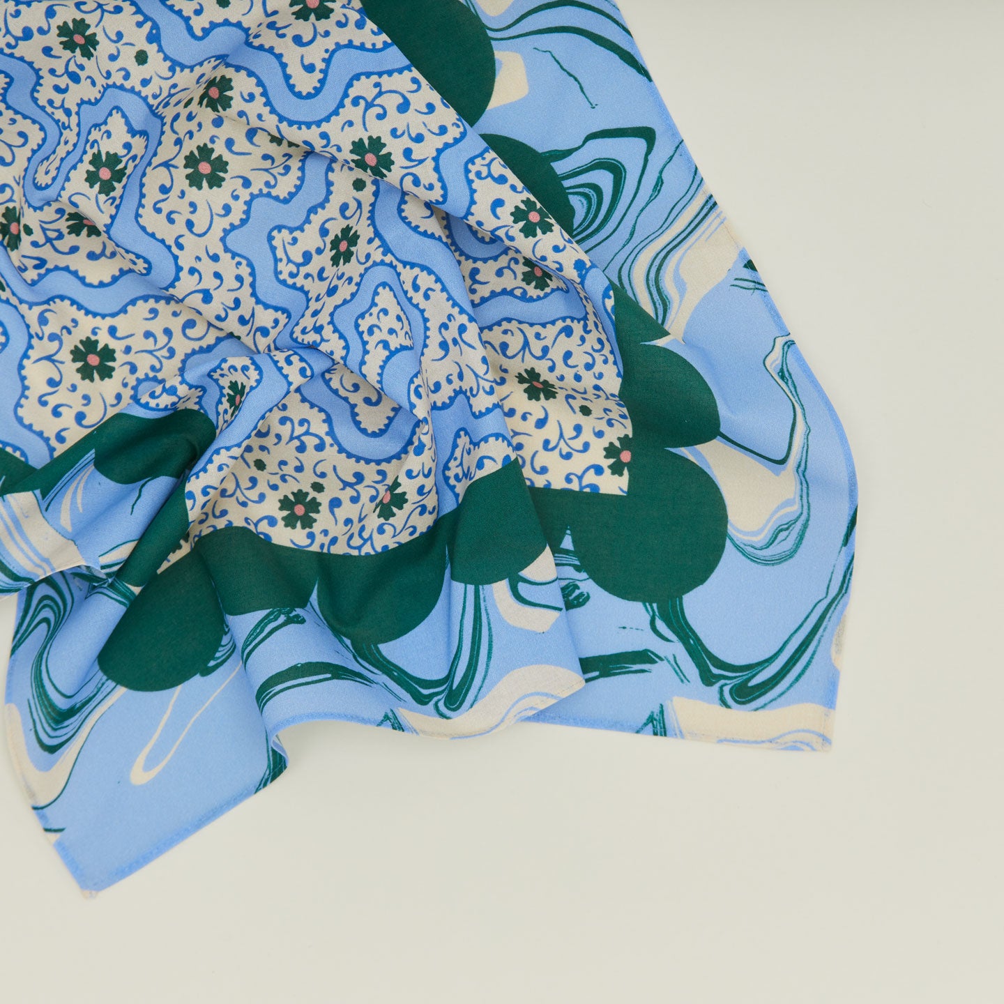 A close up of a mixed floral napkin with a cornflower pattern.