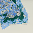 A close up of a mixed floral napkin with a cornflower pattern.