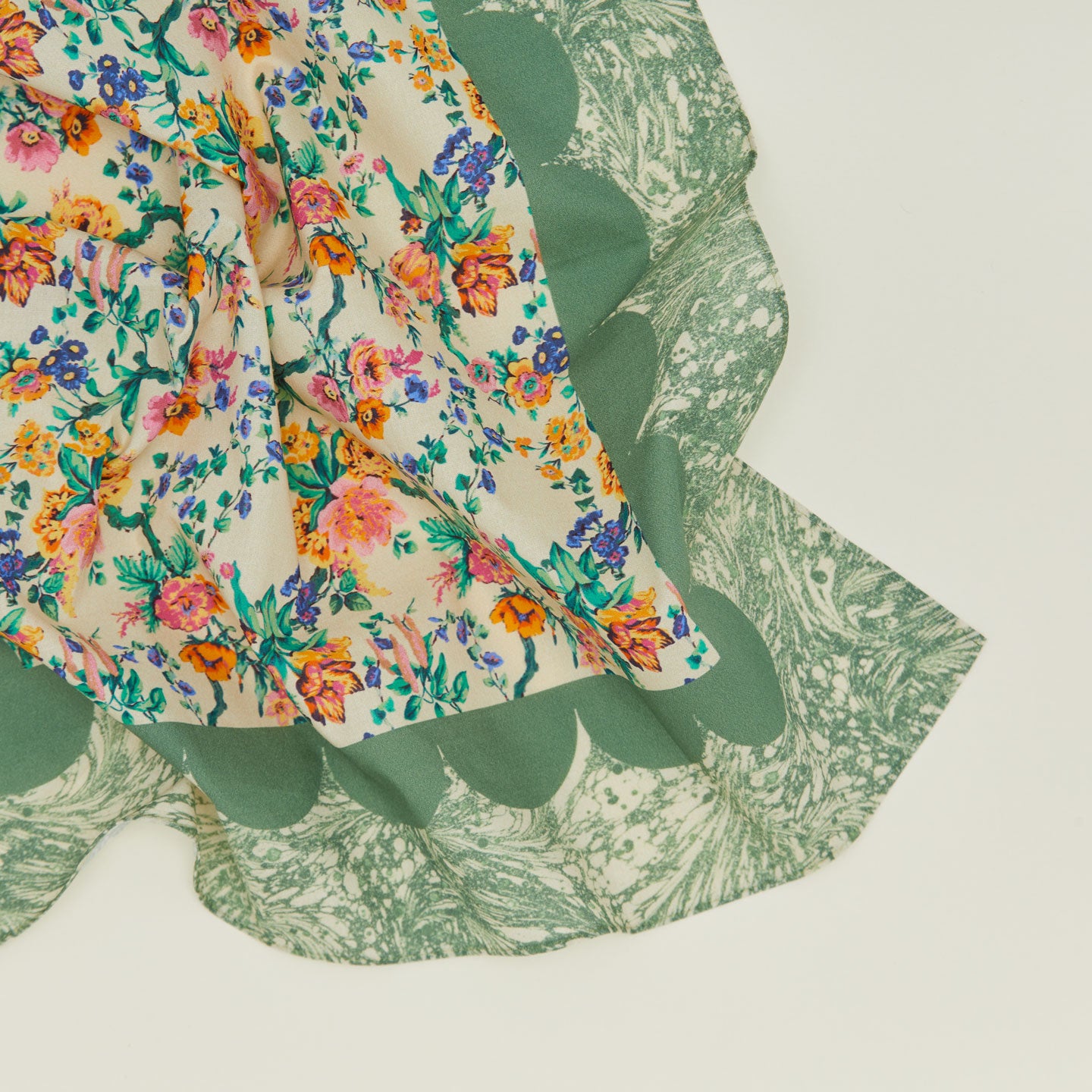 A close up of a mixed floral napkin with a fern pattern.