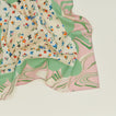 A close up of a mixed floral napkin with a fern pattern.