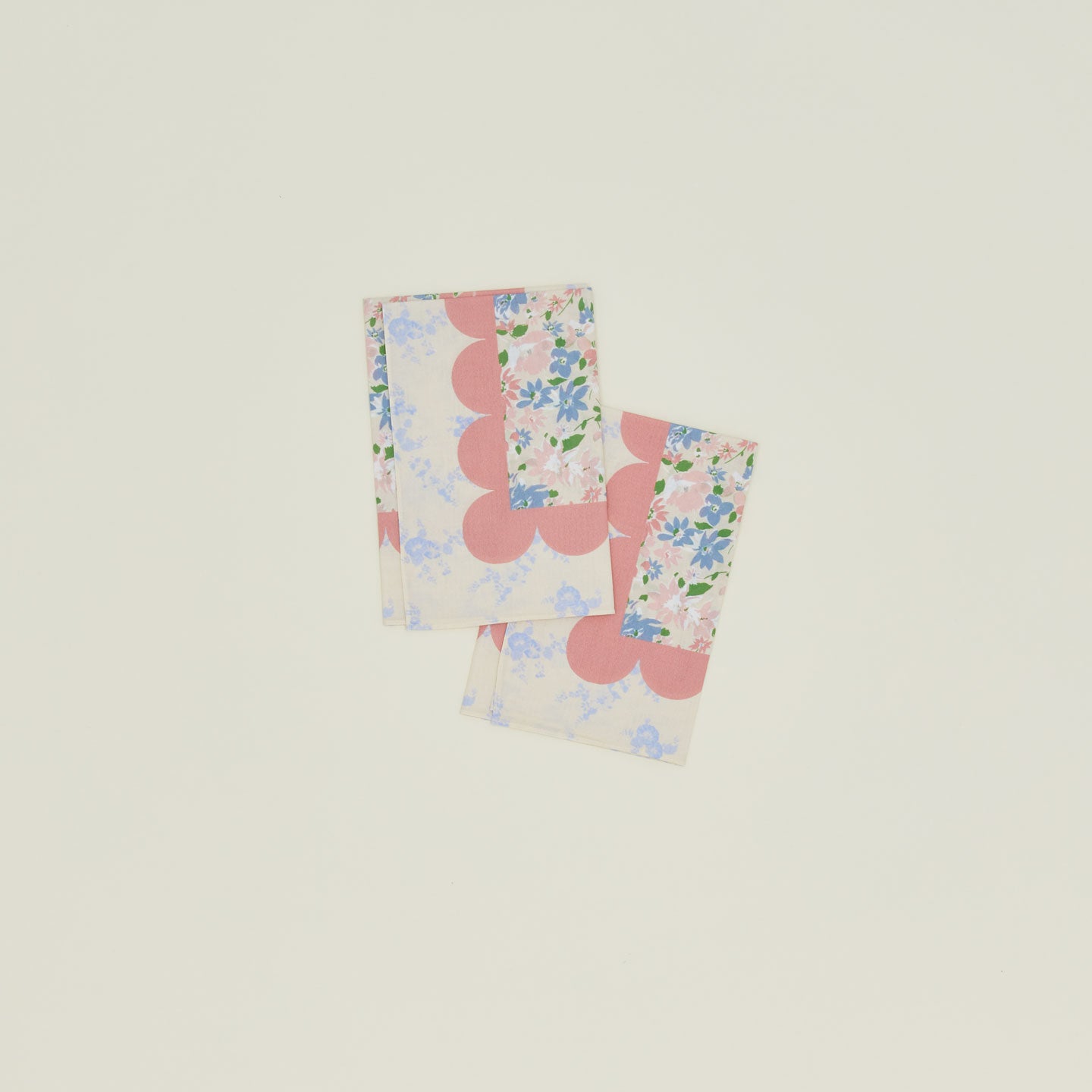 A set of two mixed floral napkins with a rose pattern.
