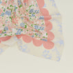 A close up of a mixed floral napkin with a rose pattern.