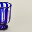 Close up view of blue striped wine glass