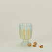 White striped wine glass with pistachios