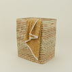 Open weave hamper with mustard space dye towel draped over the side