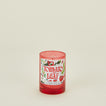 Candle with a 'Tomato Leaf' label on a beige background