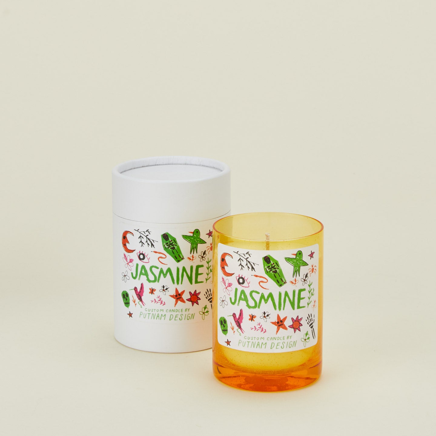 Candle with 'Jasmine' label and cylindrical container on a white background