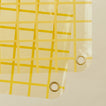 Close up view of sun grid shower curtain in butter